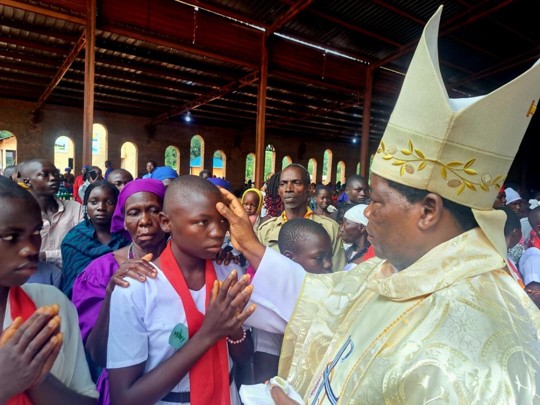 Over 260 Catholics Receive Sacrament of Confirmation in Honor of Late Bishop Joseph Gasi Abangite By Baraka John As the Christian community marked 11th anniversary of the passing of the late Bishop Emeritus Joseph Gasi Abangite, 268 Catholics on Friday 12th 2025 in a solemn celebration received the sacrament of confirmation in his honor. Confirmation in the Catholic Church is the sacrament that strengthens and completes a Christian's initiation into the faith. It empowers them with the Holy Spirit to live a faithful, courageous life of discipleship in the Church and the world. It is a sacred rite in which a baptized person is strengthened and sealed with the gift of the Holy Spirit. In his Homily, Bishop Hiiboro encouraged the new faithful to embrace the spirit of Holy Spirit in their daily lives, and love for humanity. “This sacrament is not just a rite of passage,” said bishop, “It is a continuation of Bishop Gasi’s legacy a legacy rooted in deep faith, hope, and love for his people. Today, you take on the responsibility of living as true Christians, just as Bishop Gasi encouraged us to.” The anniversary, held at St. Mary’s Cathedral in Yambio, brought together faithful from across the diocese. The event was presided over by the diocesan bishop, His lordship Eduardo Hiiboro Kusala who offered special blessings in remembrance of Bishop Gasi’s life, legacy, and service to the Church. Bishop Joseph Gasi Abangite, who served as the Bishop of the Catholic Diocese of Tombura-Yambio for several decades, is remembered as a pillar of faith and unity during some of South Sudan’s most turbulent years. His pastoral care, commitment to peace, and dedication to the spiritual growth of his flock continue to inspire generations. The sacrament of confirmation, which strengthens the baptized in their faith through the gifts of the Holy Spirit, was administered to over 300 candidates a symbolic gesture reflecting the ongoing spiritual growth within the diocese. The Diocese of Tombura-Yambio commemorates Bishop Gasi’s life annually, using the occasion to renew the faith of its members and inspire future generations to walk in his footsteps. Over 260 Catholics Receive Sacrament of Confirmation in Honor of Late Bishop Joseph Gasi Abangite By Baraka John As the Christian community marked 11th anniversary of the passing of the late Bishop Emeritus Joseph Gasi Abangite, 268 Catholics on Friday 12th 2025 in a solemn celebration received the sacrament of confirmation in his honor. Confirmation in the Catholic Church is the sacrament that strengthens and completes a Christian's initiation into the faith. It empowers them with the Holy Spirit to live a faithful, courageous life of discipleship in the Church and the world. It is a sacred rite in which a baptized person is strengthened and sealed with the gift of the Holy Spirit. In his Homily, Bishop Hiiboro encouraged the new faithful to embrace the spirit of Holy Spirit in their daily lives, and love for humanity. “This sacrament is not just a rite of passage,” said bishop, “It is a continuation of Bishop Gasi’s legacy a legacy rooted in deep faith, hope, and love for his people. Today, you take on the responsibility of living as true Christians, just as Bishop Gasi encouraged us to.” The anniversary, held at St. Mary’s Cathedral in Yambio, brought together faithful from across the diocese. The event was presided over by the diocesan bishop, His lordship Eduardo Hiiboro Kusala who offered special blessings in remembrance of Bishop Gasi’s life, legacy, and service to the Church. Bishop Joseph Gasi Abangite, who served as the Bishop of the Catholic Diocese of Tombura-Yambio for several decades, is remembered as a pillar of faith and unity during some of South Sudan’s most turbulent years. His pastoral care, commitment to peace, and dedication to the spiritual growth of his flock continue to inspire generations. The sacrament of confirmation, which strengthens the baptized in their faith through the gifts of the Holy Spirit, was administered to over 300 candidates a symbolic gesture reflecting the ongoing spiritual growth within the diocese. The Diocese of Tombura-Yambio commemorates Bishop Gasi’s life annually, using the occasion to renew the faith of its members and inspire future generations to walk in his footsteps. Bishop Hiiboro giving sacrament of confirmation, Picture by Ernesto Joseph Chakaya